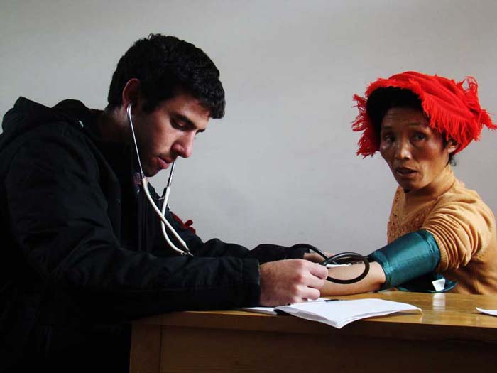 chinacal volunteer eric examining a patient